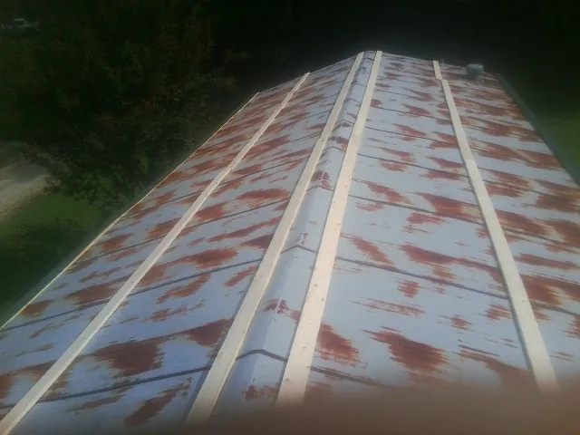 Rusted metal roof panels with new wood purlins before replacement — Storm Damage Roof Repair in Pine Meadow by Roofing Brothers